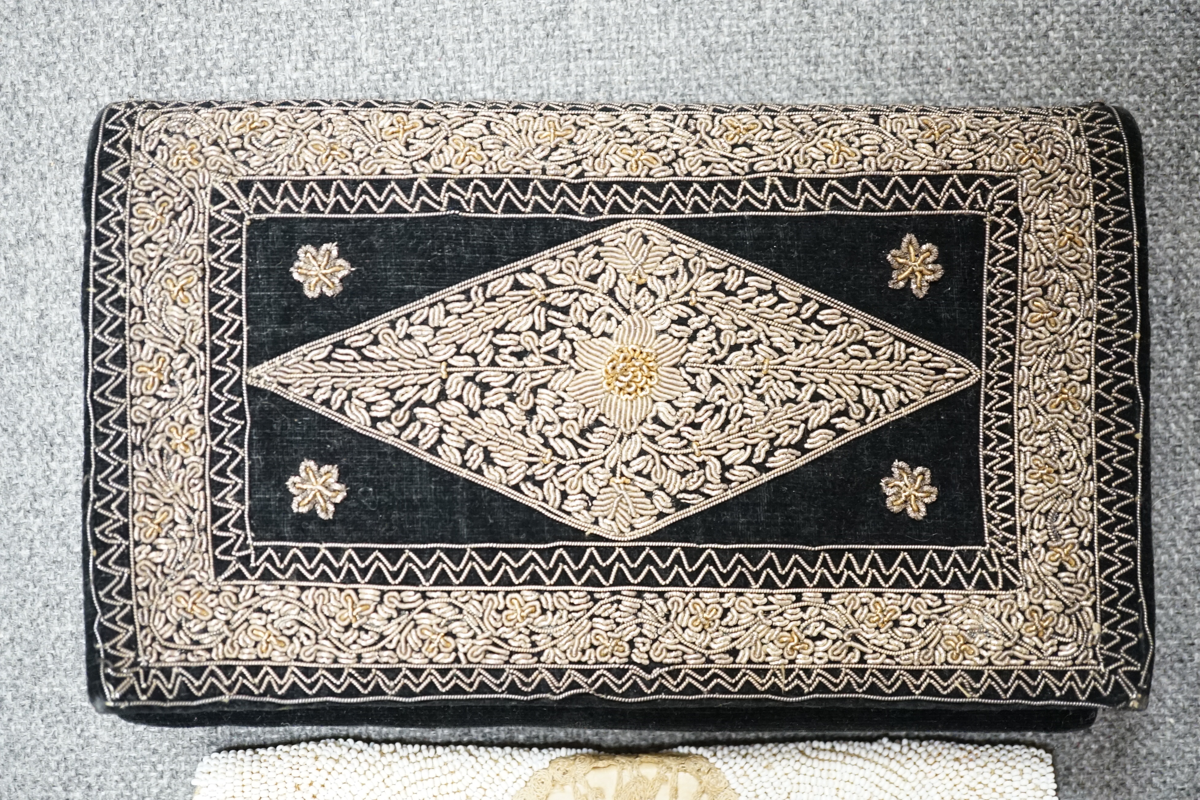 A 1940’s black velvet gold and silver embroidered evening clutch bag and an earlier 1930’s bead worked evening bag and an another black velvet bag,1940’s clutch bag 21cm wide. Condition - black bag good, white bead bag i